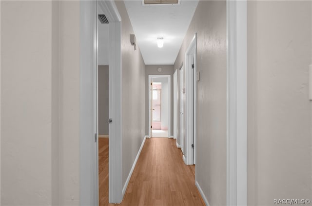 corridor with light wood-type flooring