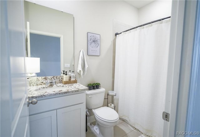 bathroom featuring vanity, toilet, and a shower with curtain