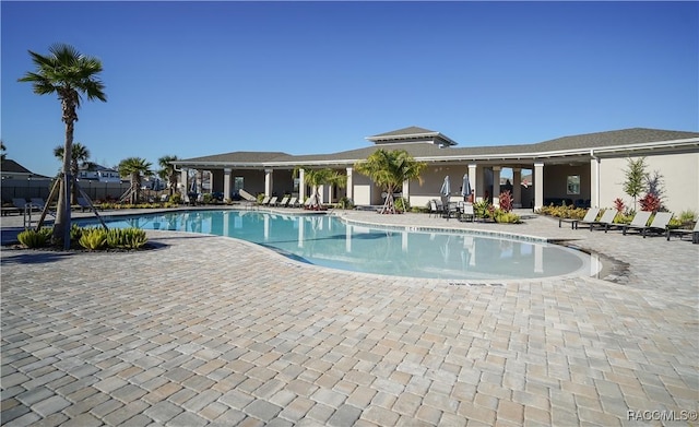 pool featuring a patio area and fence