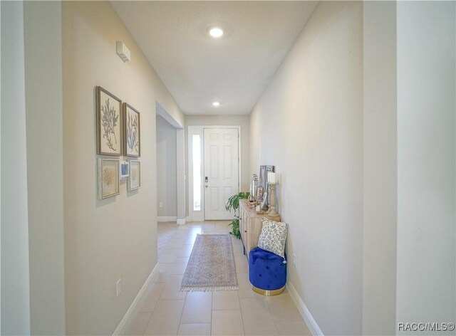 doorway to outside with light tile patterned flooring, recessed lighting, and baseboards