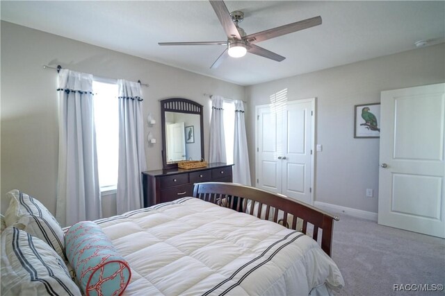 bedroom featuring baseboards, carpet floors, and ceiling fan