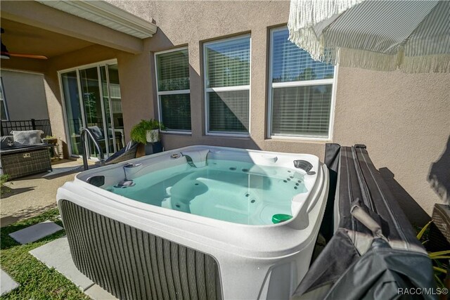 view of patio / terrace with a hot tub