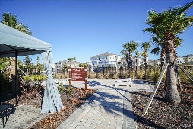 exterior space with a gazebo, a residential view, and fence