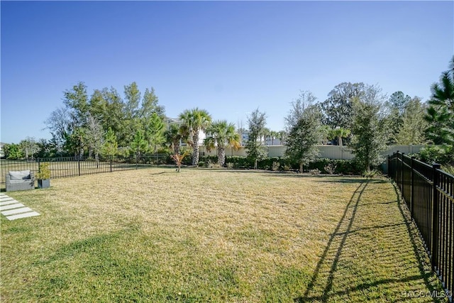 view of home's community with a yard and fence