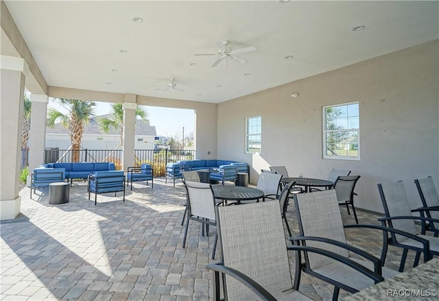 view of patio with outdoor dining space, outdoor lounge area, a ceiling fan, and fence