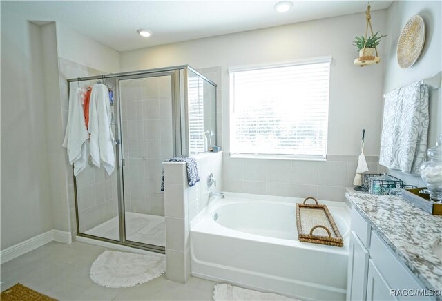 bathroom with vanity, a shower stall, a bath, and tile patterned flooring