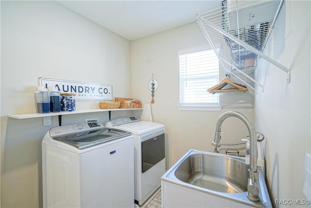 laundry area with a sink, laundry area, and washing machine and clothes dryer