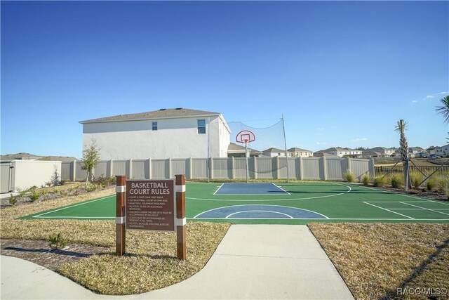 view of basketball court featuring community basketball court and fence