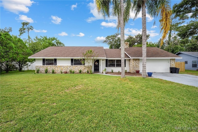 single story home featuring a garage and a front lawn