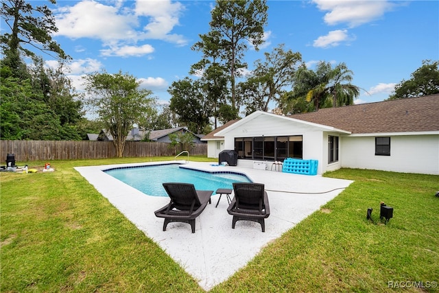 view of pool featuring a yard and a patio