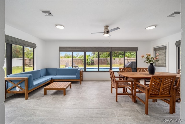 dining room featuring ceiling fan and a healthy amount of sunlight