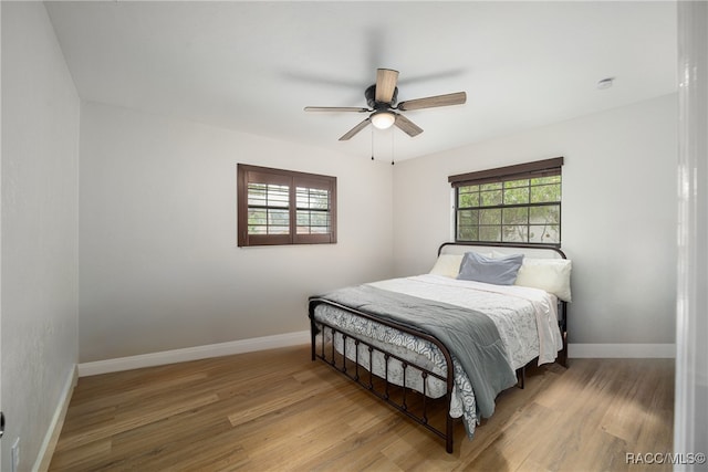 bedroom with hardwood / wood-style floors and ceiling fan