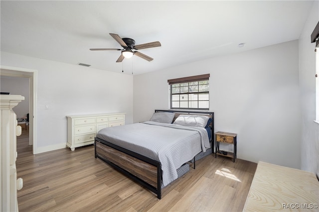 bedroom with ceiling fan and light hardwood / wood-style flooring