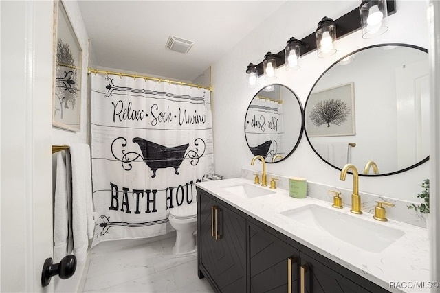 bathroom with vanity, a shower with shower curtain, and toilet