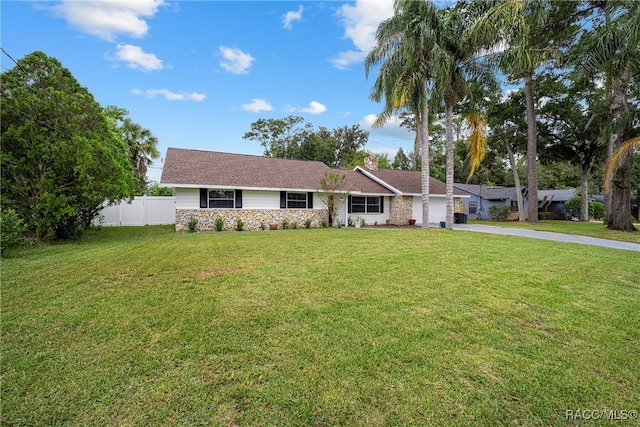 ranch-style home featuring a front yard and a garage