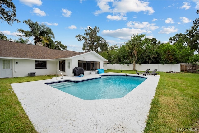 view of swimming pool featuring area for grilling, a patio area, and a yard