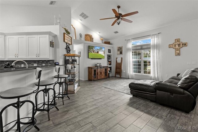 5317 W Tortuga Loop, Lecanto, FL 34461 - living room with ceiling fan, wood finished floors, and high vaulted ceiling