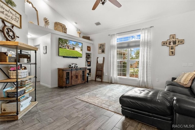 5317 W Tortuga Loop, Lecanto, FL 34461 - living room with a ceiling fan, wood finished floors, and high vaulted ceiling