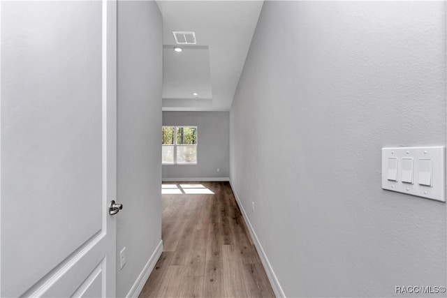 hallway with light hardwood / wood-style floors