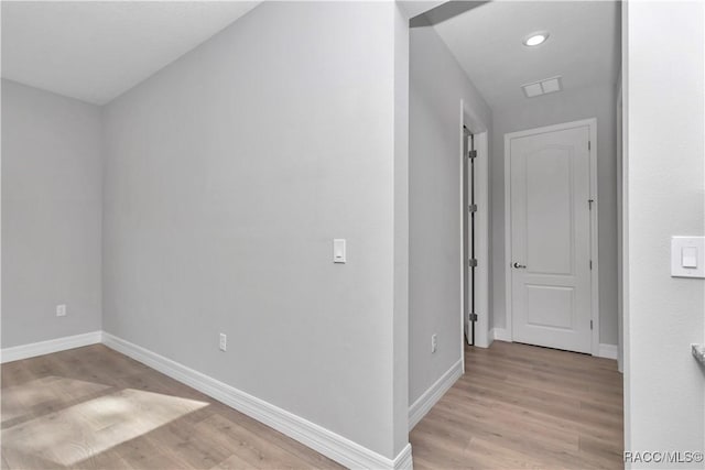 corridor with light hardwood / wood-style flooring