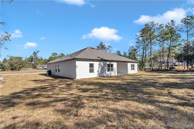 back of house with a yard and central AC unit