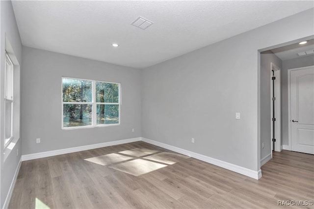 spare room featuring light hardwood / wood-style flooring