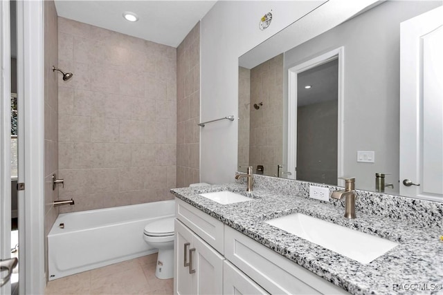 full bathroom featuring toilet, tiled shower / bath combo, vanity, and tile patterned floors