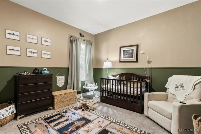 carpeted bedroom with a nursery area