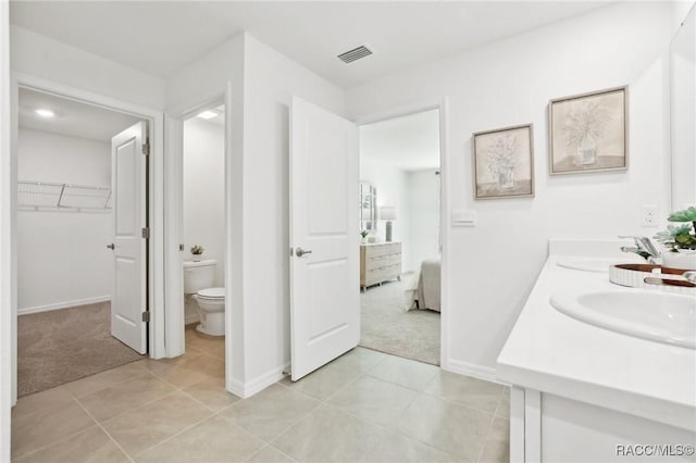 2838 W Vespero St, Citrus Springs, FL 34434 - full bathroom featuring double vanity, tile patterned flooring, toilet, and baseboards