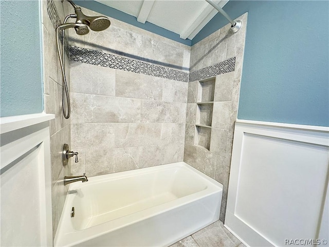 bathroom featuring tile patterned floors and tiled shower / bath combo