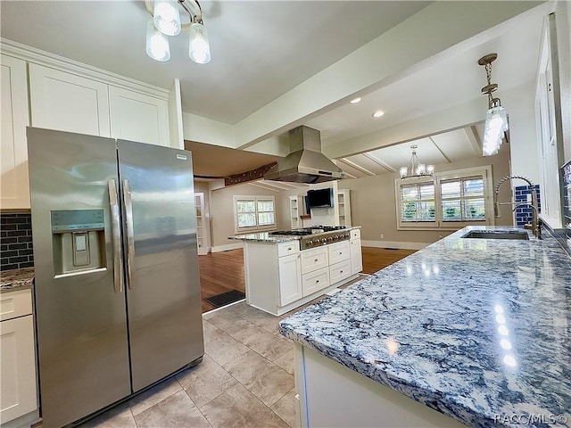 kitchen with appliances with stainless steel finishes, island range hood, sink, vaulted ceiling with beams, and white cabinetry