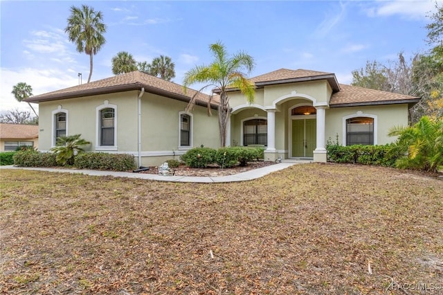 mediterranean / spanish-style house with a front yard