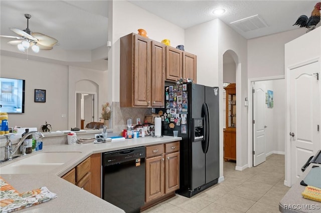 kitchen featuring black appliances, decorative backsplash, sink, ceiling fan, and light tile patterned floors