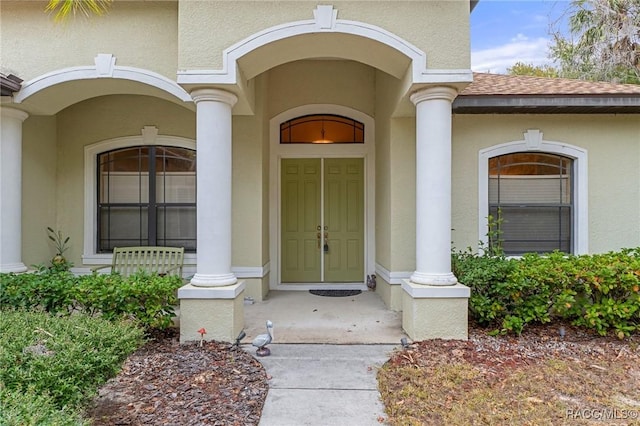 view of exterior entry featuring covered porch