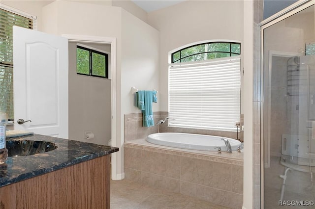 bathroom with vanity, independent shower and bath, and tile patterned flooring