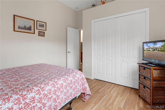 bedroom with light wood-type flooring and a closet