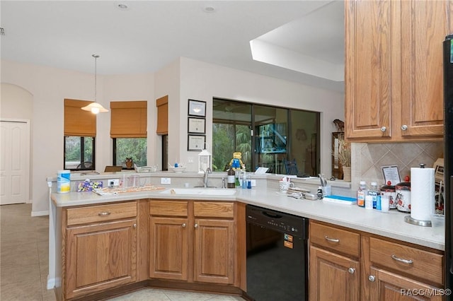 kitchen with dishwasher, decorative backsplash, sink, hanging light fixtures, and kitchen peninsula