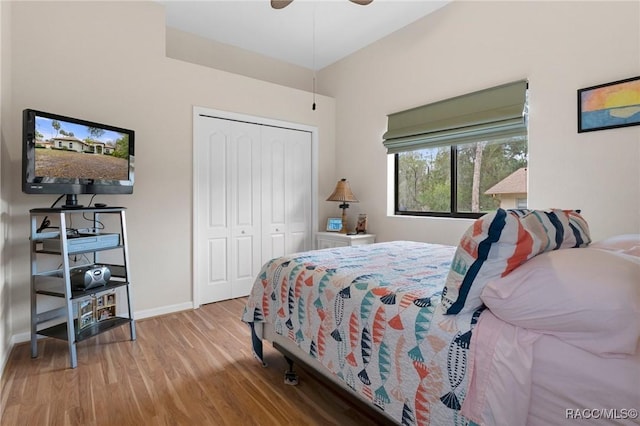 bedroom with ceiling fan, a closet, and light wood-type flooring