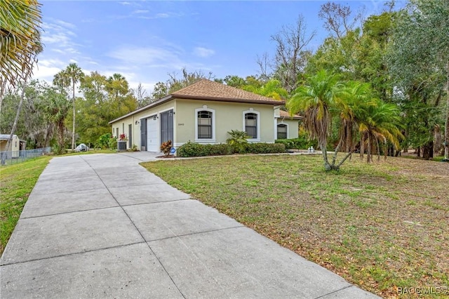 view of front of property with a front lawn and a garage