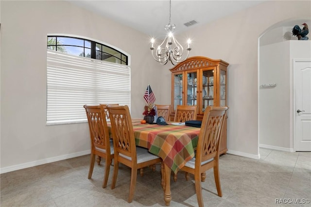 dining space featuring a chandelier and light tile patterned flooring