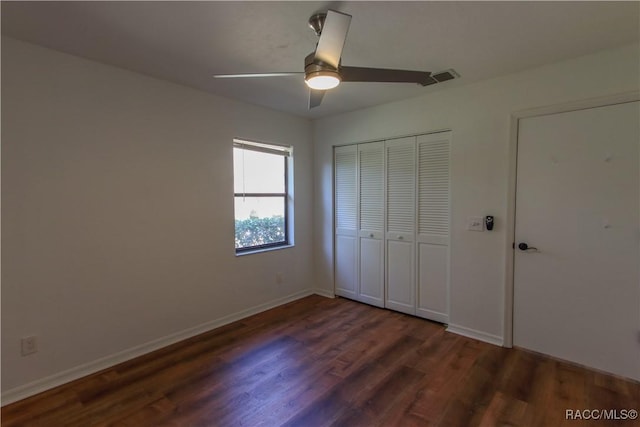 unfurnished bedroom featuring baseboards, a closet, and wood finished floors