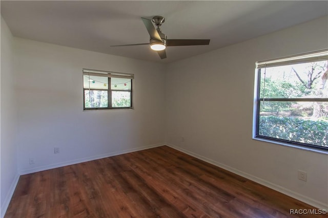 spare room with a ceiling fan, baseboards, and wood finished floors