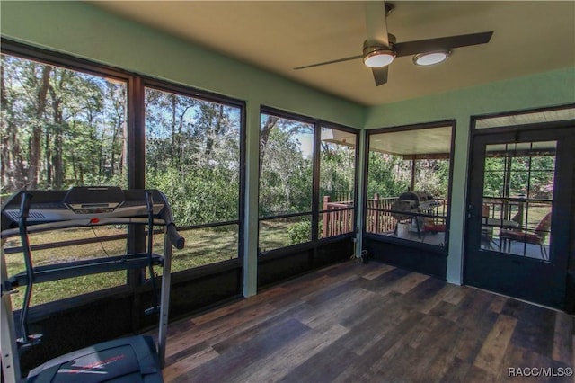 unfurnished sunroom featuring a ceiling fan