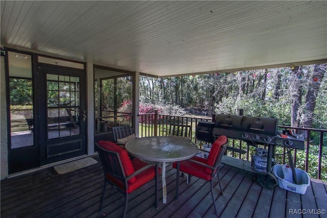 wooden terrace featuring outdoor dining area