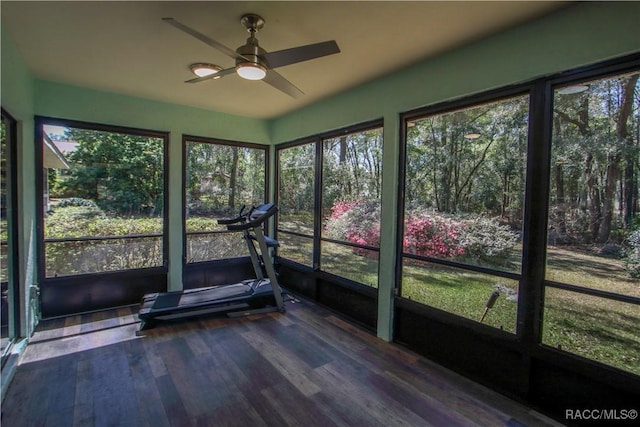 unfurnished sunroom with ceiling fan