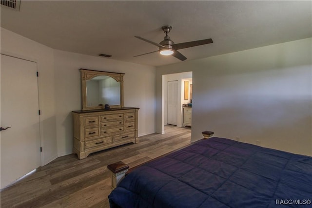 bedroom with ceiling fan, light wood finished floors, and visible vents