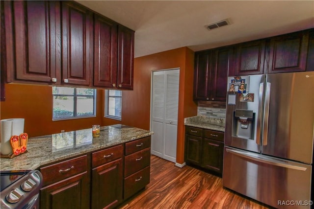 kitchen featuring tasteful backsplash, visible vents, dark wood finished floors, light stone counters, and stainless steel appliances