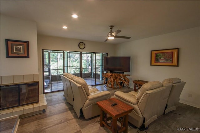 living room with a fireplace, a ceiling fan, wood finished floors, and recessed lighting