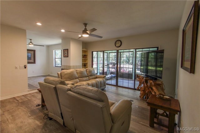 living area with a ceiling fan, baseboards, wood finished floors, and recessed lighting