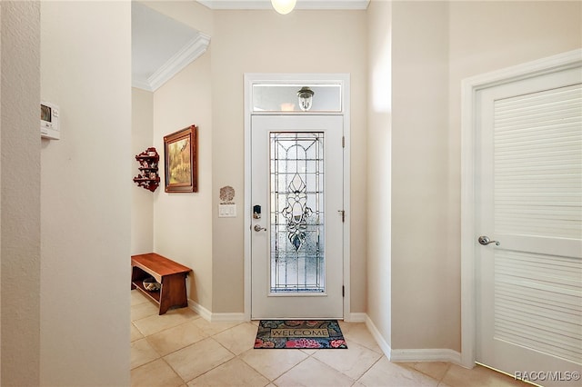 foyer featuring light tile patterned floors and crown molding